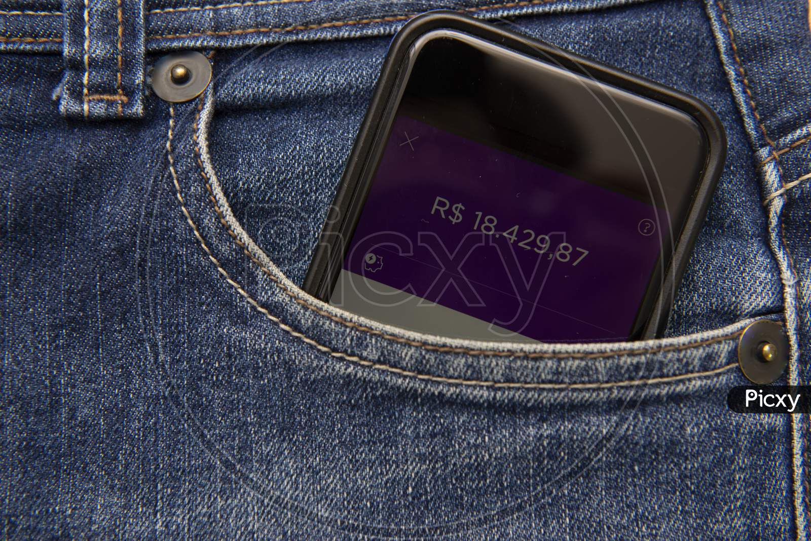 Close Up Of Cellphone In Pants Pocket Showing Screen With Positive Money Balance. Investment Income. Concept Of Economic Success. Virtual Money In Your Pocket.