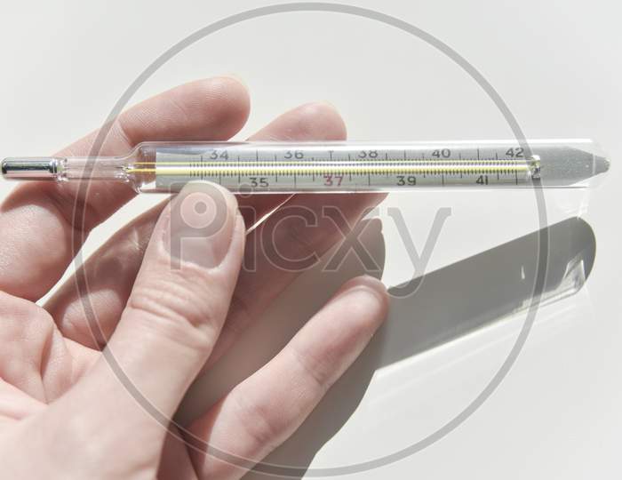 Thermometer In The Female Hand