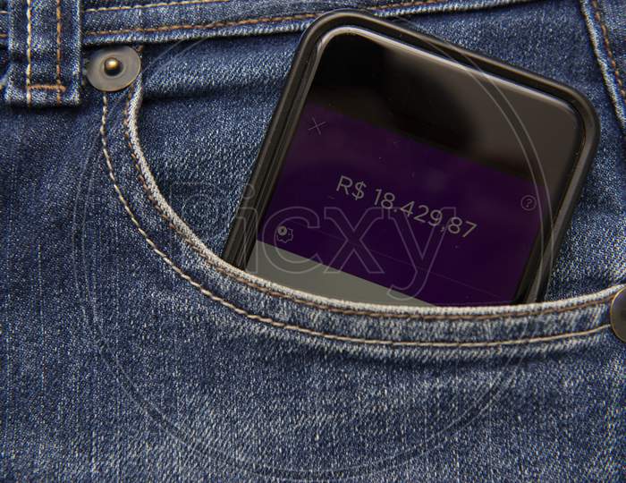Close Up Of Cellphone In Pants Pocket Showing Screen With Positive Money Balance. Investment Income. Concept Of Economic Success. Virtual Money In Your Pocket.