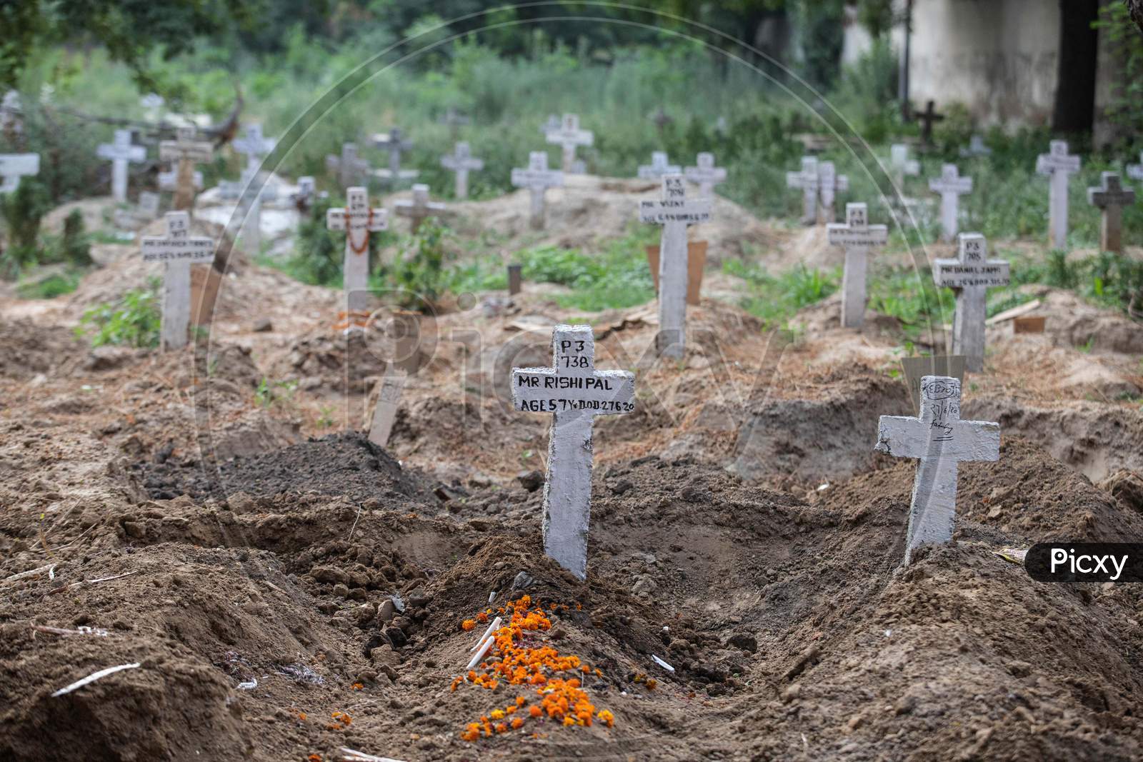 Flowers Over Fresh Grave Of  Covid-19 Victims  At Mangolpuri Cemetery  On July 1, 2020 In New Delhi, India.