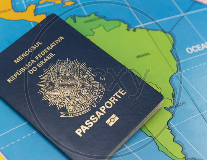 Top View Of Brazilian Passport Over Map. Focus On The South American Continent. Emigration, Travel, Destination Concept.