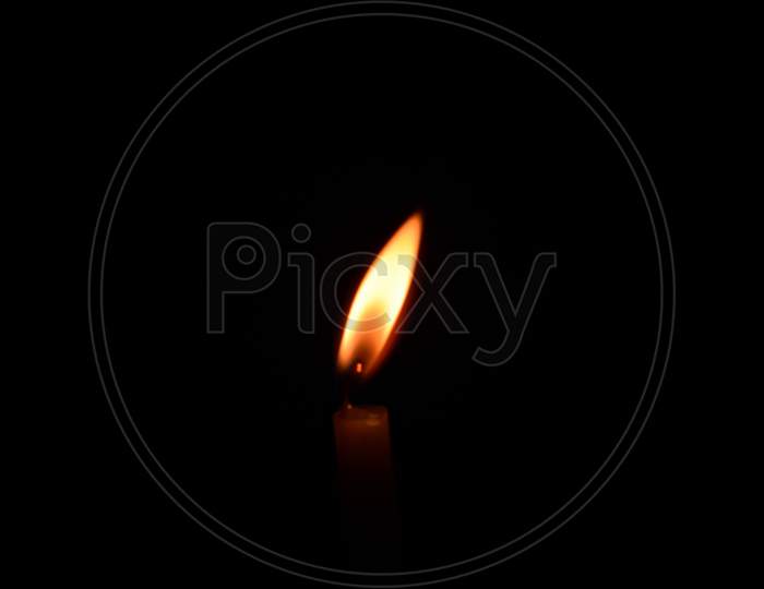 Burning candle on black background, Candle in the dark