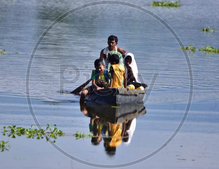 Flood Affected Villagers Are Transported On A Makeshift Raft Towards A Safer Place At At Baghmari Village Near Kaziranga In Nagaon District Of Assam On June 30,2020.