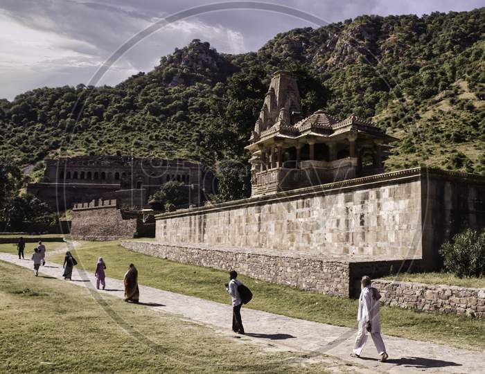 Rajasthan, India - October 06, 2012: People Walking In Distance Around Abandoned Cursed Ruined Fort In A Place Named Ajabgarh On A Way To Allegedly Haunted Place Bhangarh Fort