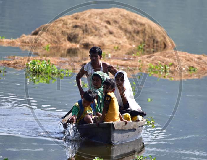 Flood Affected Villagers Are Transported On A Makeshift Raft Towards A Safer Place At At Baghmari Village Near Kaziranga In Nagaon District Of Assam On June 30,2020.