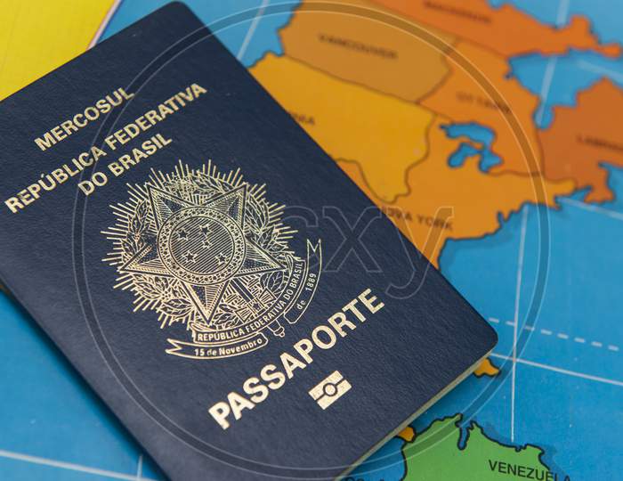 Top View Of Brazilian Passport Over Map. Focus On The North American Continent. Emigration, Travel, Destination Concept.