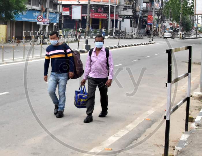 Migrant People Walk On A Deserted Street After the State Government Declared Complete Lockdown From June 29th To July 12th to Curb The Spread Of Coronavirus Disease, In Guwahati, Wednesday, July 1, 2020