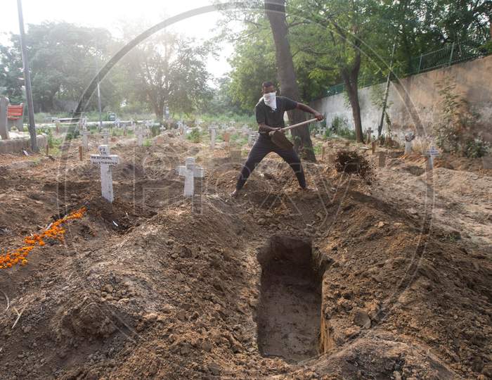 A Cemetery Worker Dugs A Grave For Covid-19 Victim At Mangolpuri Cemetery Amid The Covid-19 Pandemic On July 1, 2020 In New Delhi, India.