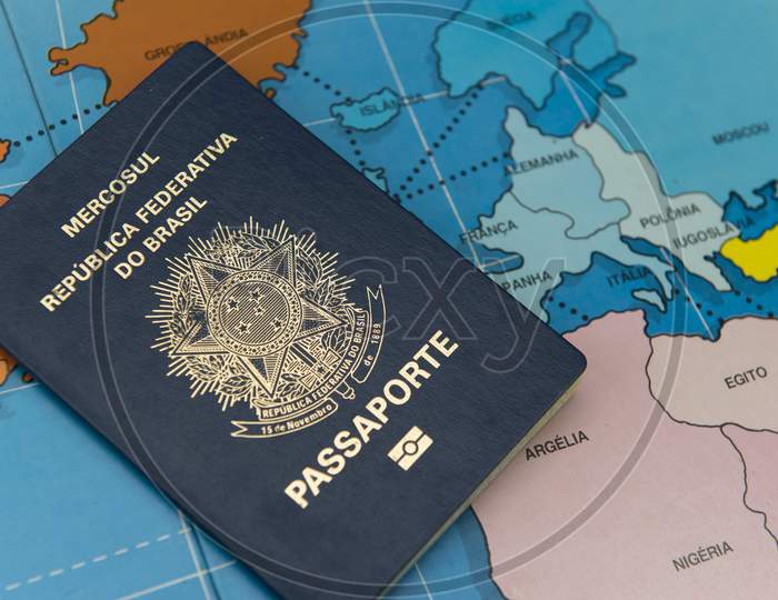 Top View Of Brazilian Passport Over Map. Focus On The European And African Continent. Emigration, Travel, Destination Concept. Translate: Mercosur, Federative Republic Of Brazil, Passport.