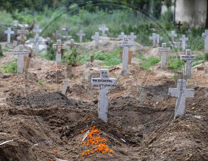 Flowers Over Fresh Grave Of  Covid-19 Victims  At Mangolpuri Cemetery  On July 1, 2020 In New Delhi, India.