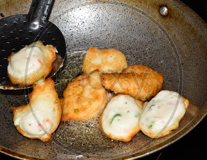 South Indian Cuisine - Vada Or Medu Vadai Frying In Coconut Oil. Very Popular South Indian Snack.