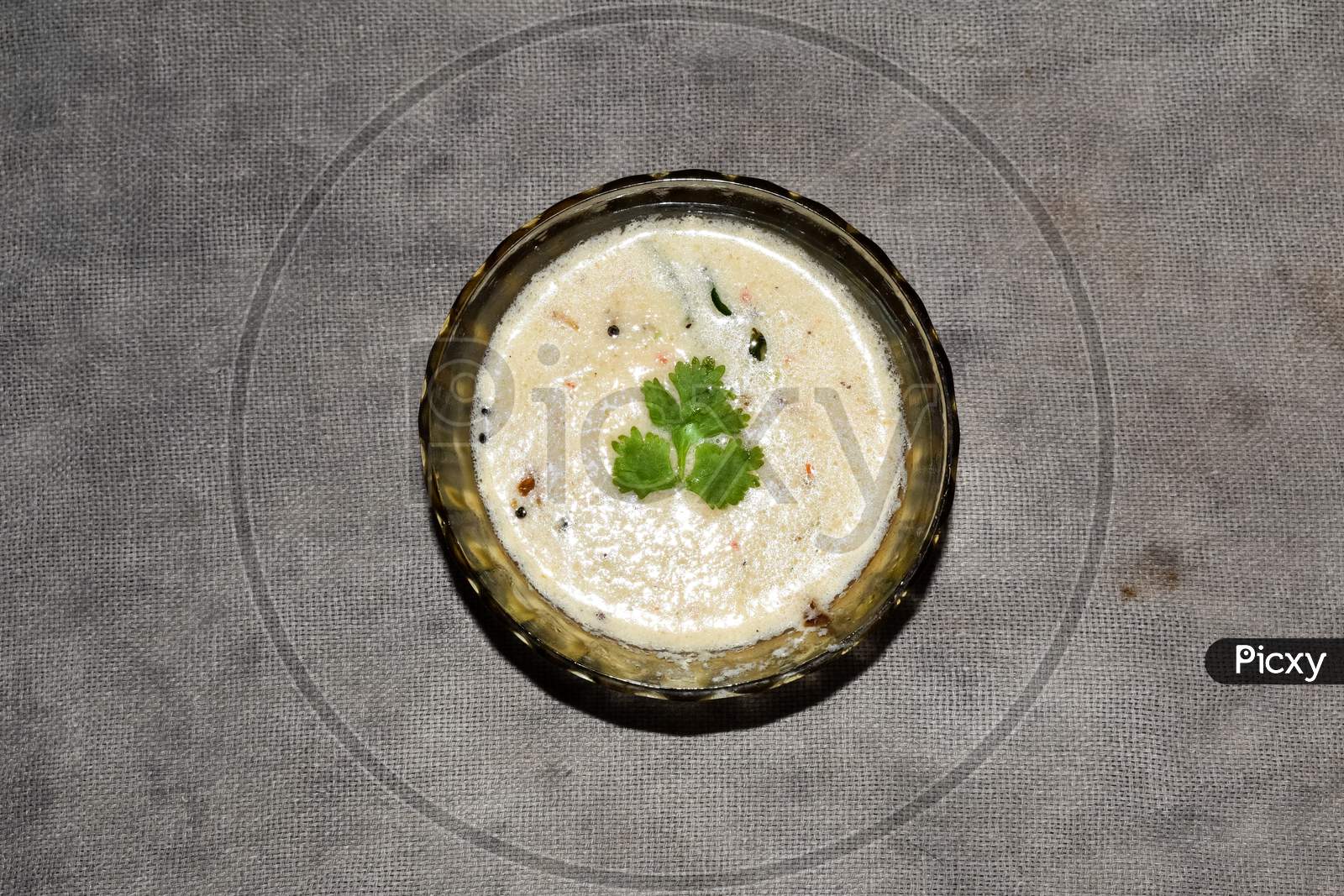 South Indian Cuisine - White Coconut Chutney Served In A Glass Bowl.