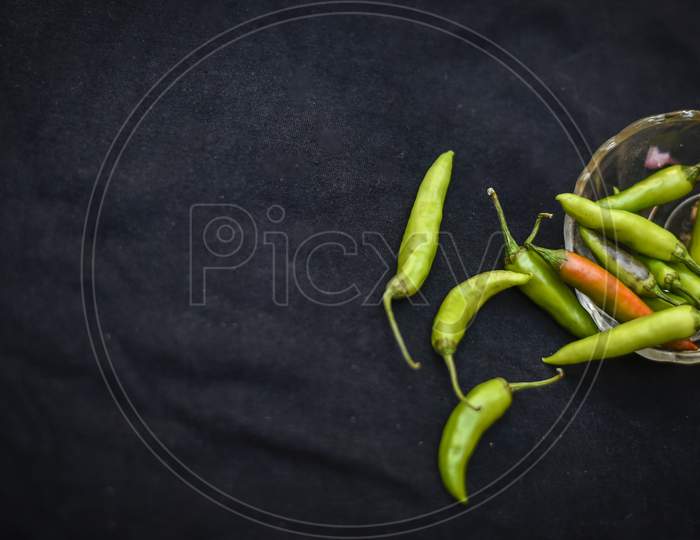 Fresh green chili isolated on black