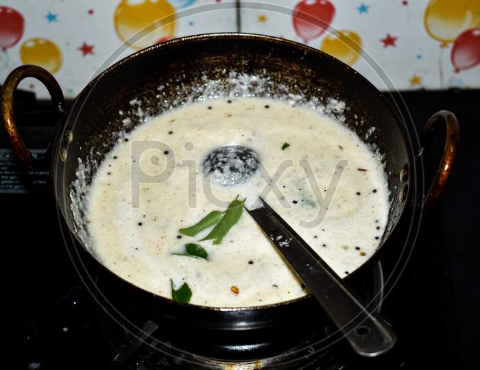 South Indian Cuisine - White Coconut Chutney Preparation In A Pan Or Khadai.Selective Focus Applied.