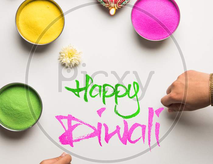 happy diwali rangoli and diya