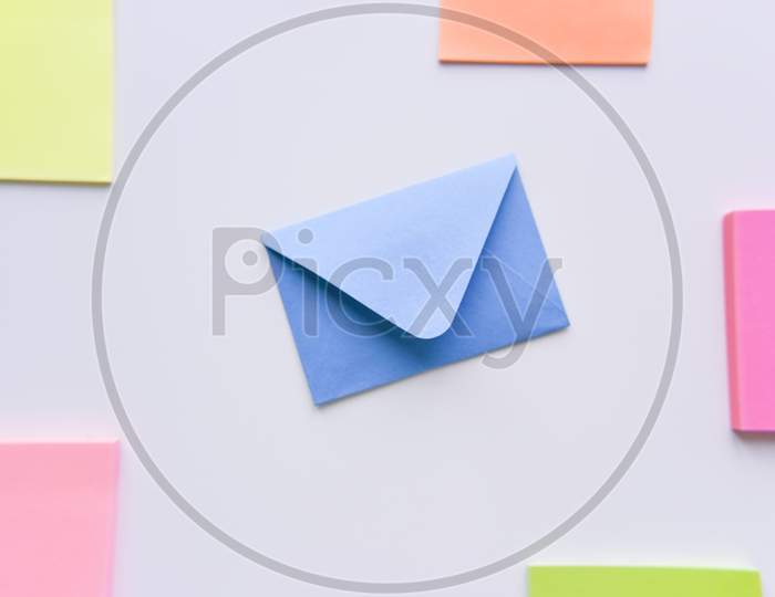 Selective Focus, Blue Envelope In The Center With Colored Rectangles On Sides
