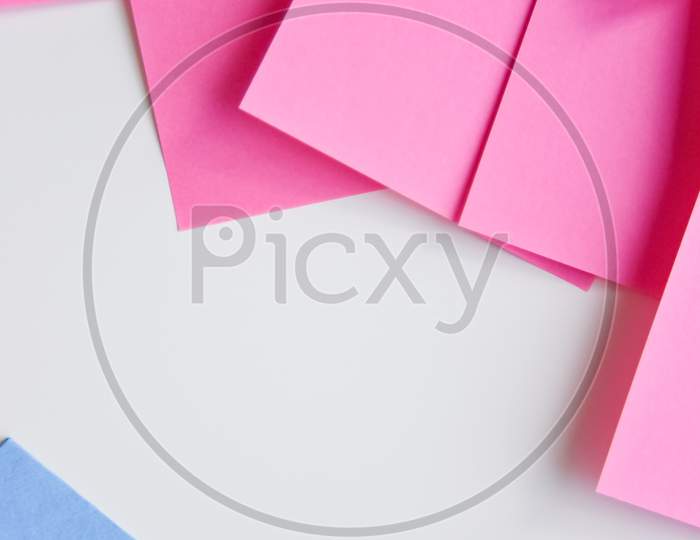 Selective Focus, Pink Stickers In One Corner And Blue One In The Opposite Corner