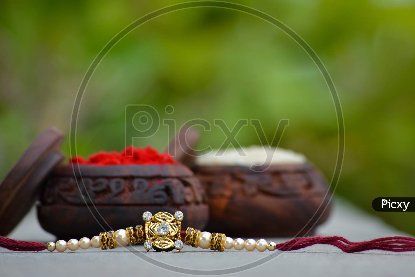 Raksha bandhan rakhi with rice grains and kumkum. A traditional indian wrist band which is a symbol of love between Brothers and Sisters