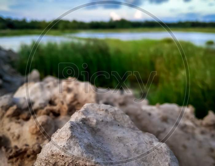 Large Pile Of Soil On Blue Sky Background. Mound And Blue Sky