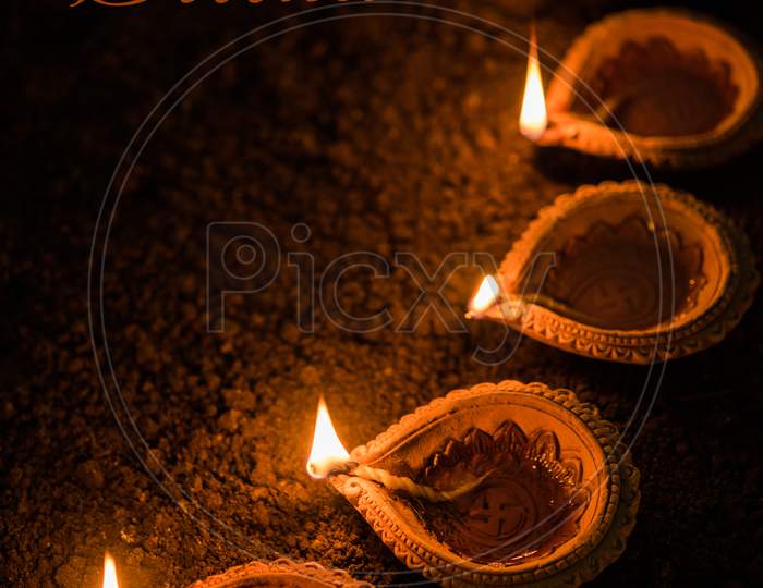Happy Diwali - many Terracotta diya or oil lamps