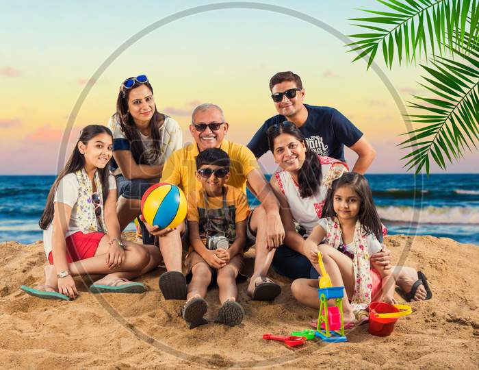 Indian/Asian Family enjoying at beach, posing for picture