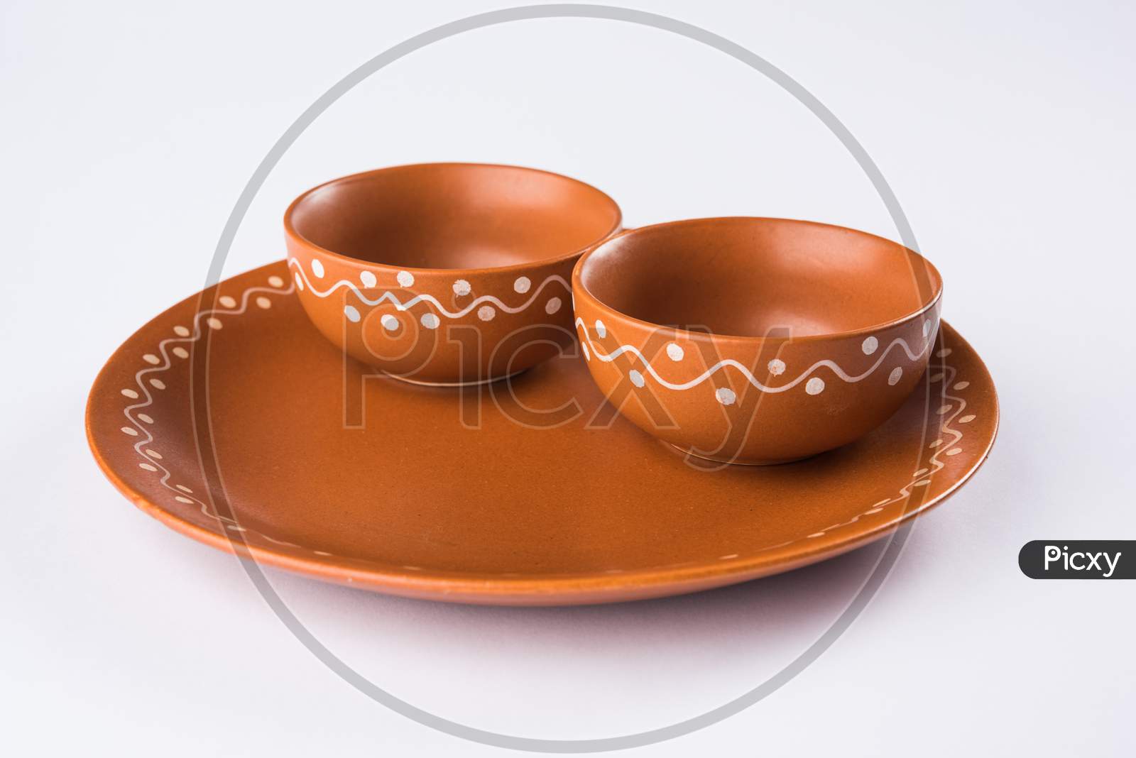Empty terracotta serving bowl or brown clay soup bowl isolated on white