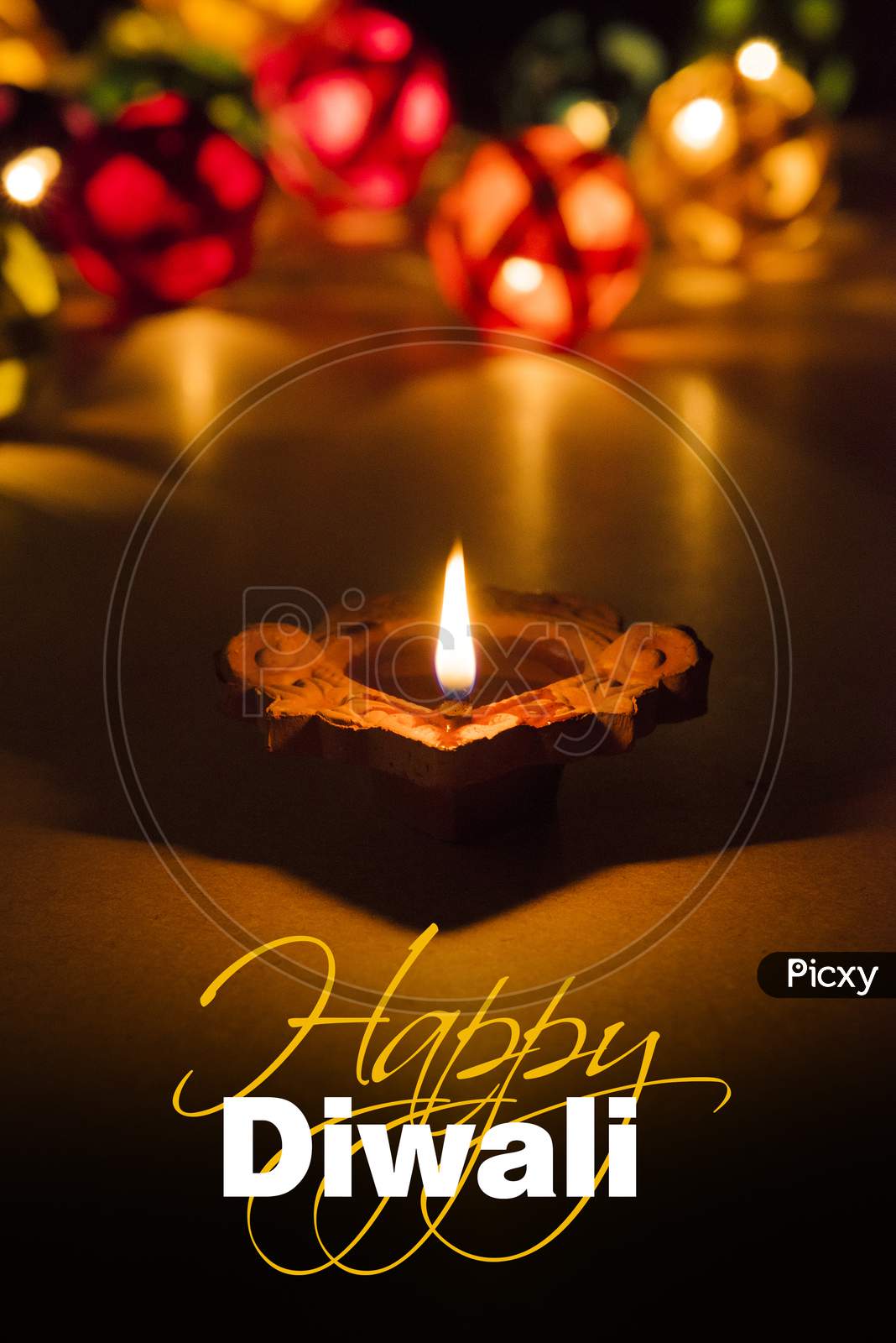 Happy Diwali Greeting Card showing Illuminated diya and bokeh