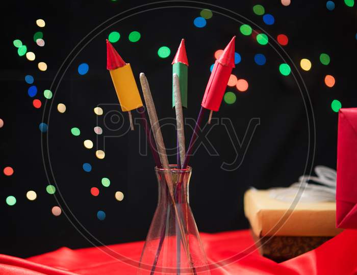 Diwali Sweets OR Mithai, Gift boxes and Crackers arranged over moody background