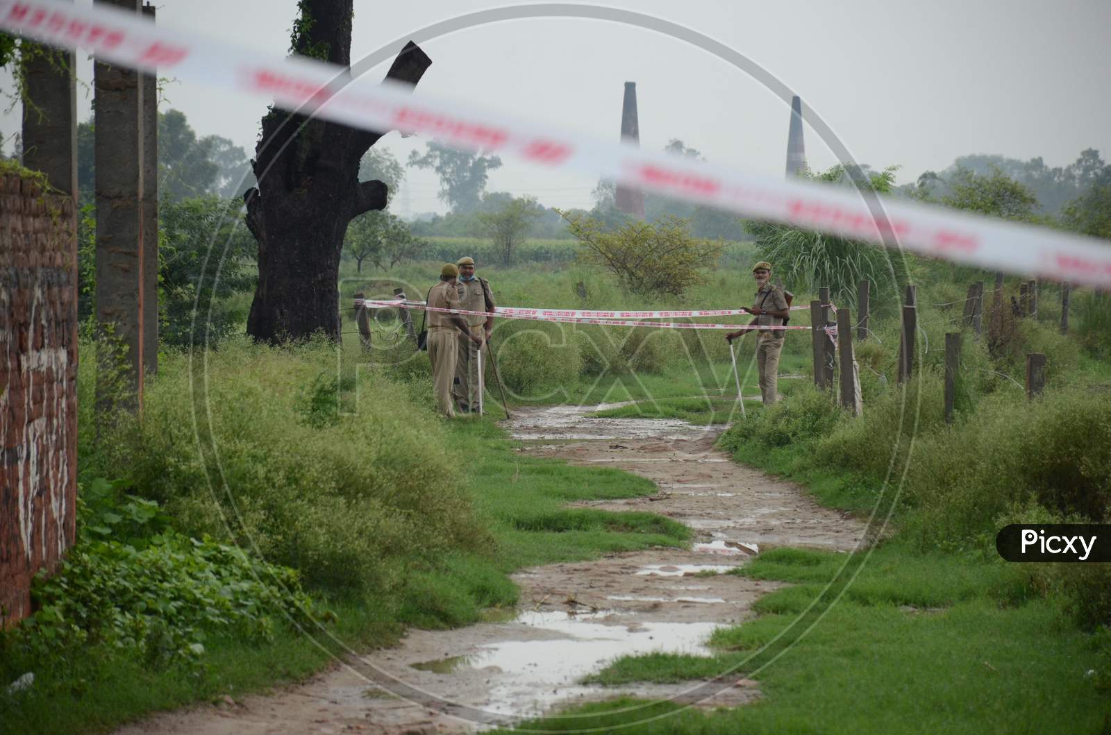 Police officials seal the  site of encounter where gangster Vikas Dubey was killed when he tried to escape from police custody in Kanpur, Uttar Pradesh on July 10, 2020