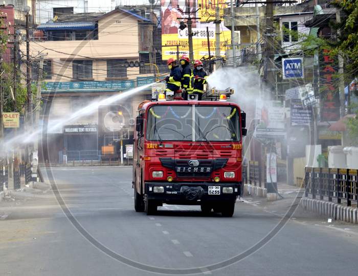 Assam State Fire and Emergency Service worker spray disinfectants
