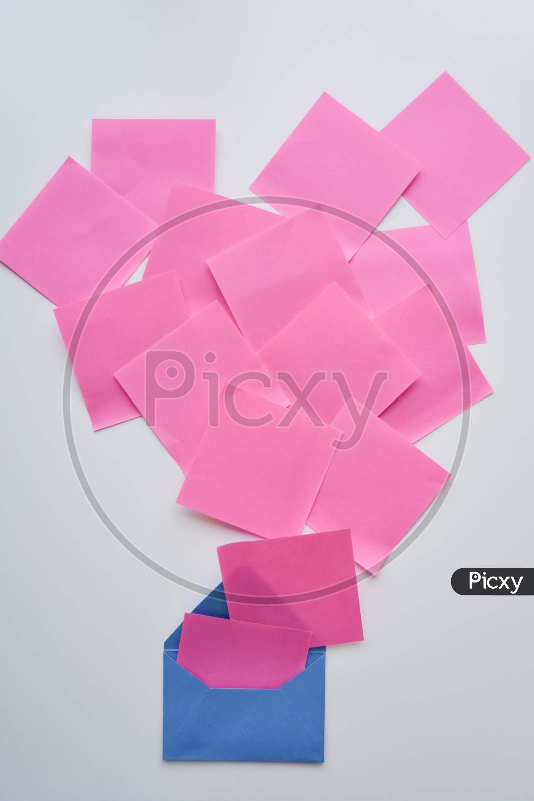 Selective Focus, Pink Paper Stickers In Chaos And Blue Envelope On The White Background