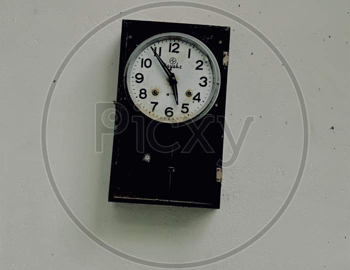 A black vintage clock on the wall