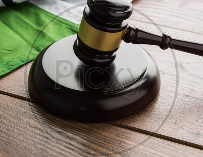 Indian Law concept showing wooden Gavel and Indian Flag
