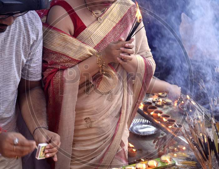 Devotees lighting  the earthen lamp to offer prayers to Lord Ganesha