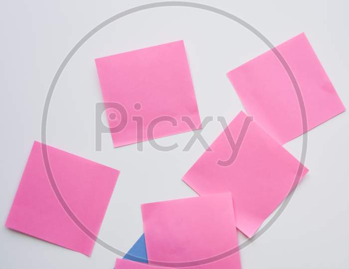 Selective Focus, Pink Paper Stickers In Chaos And Blue Envelope On The White Background