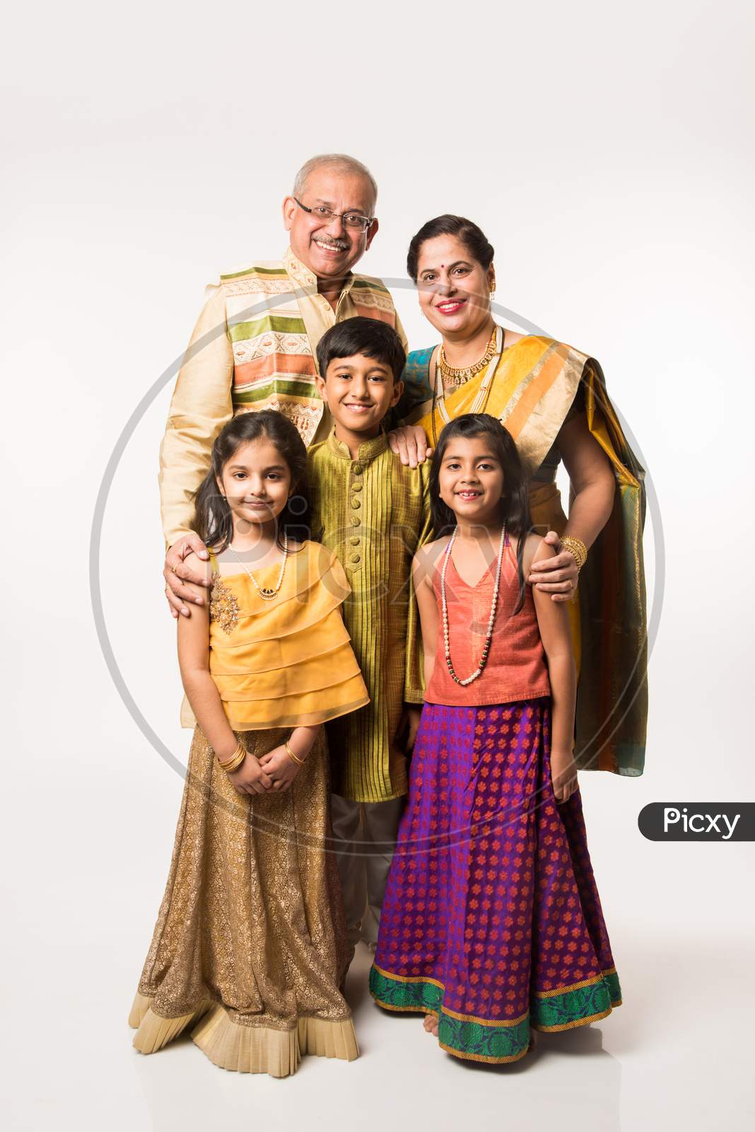 Image of Indian kids with grandparents in traditional wear holding