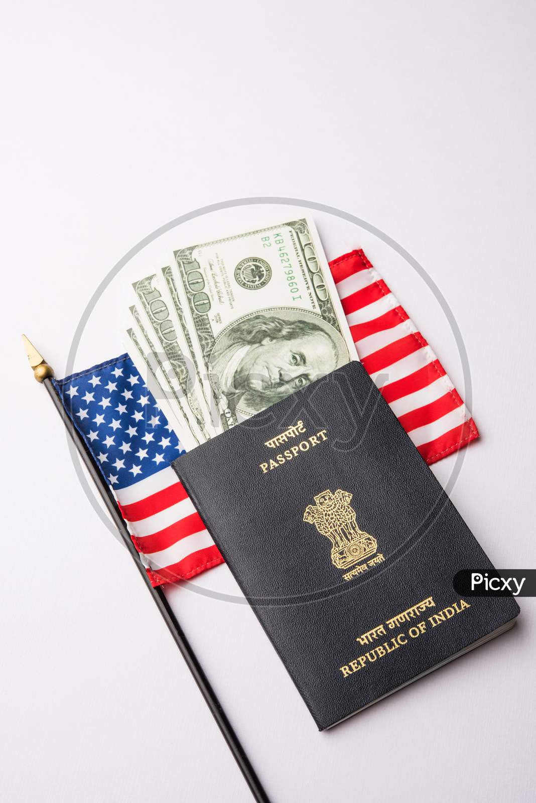 Indian passport with US Dollars with american flag in the background, Concept showing applying for tourist or H-1B visa