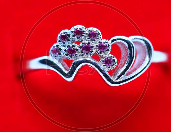 Silver Ring With Red Background