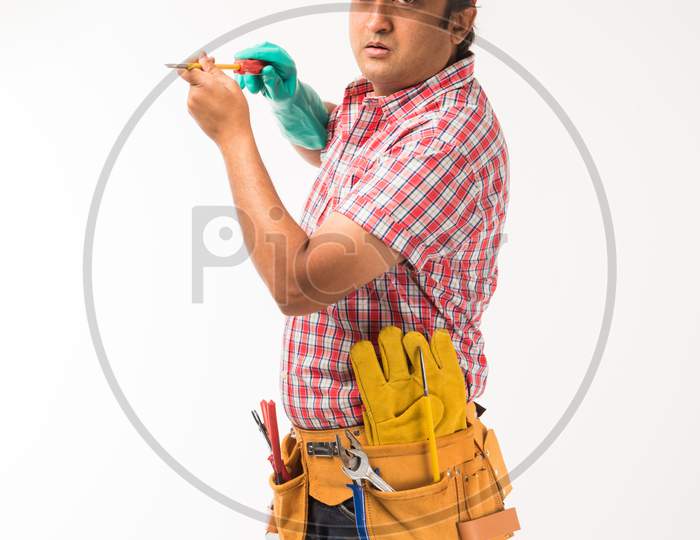 Indian/Asian electrician or electrical engineer in action
