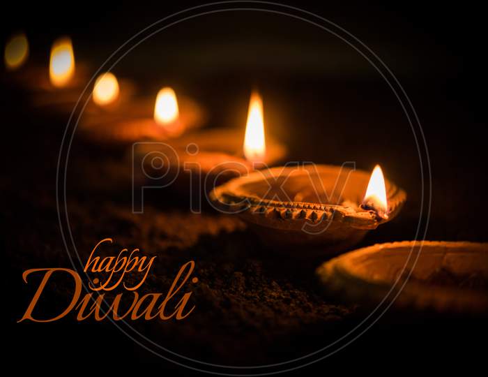 Happy Diwali - many Terracotta diya or oil lamps