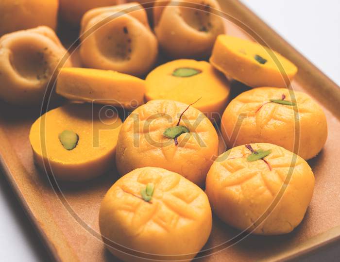 variety of sweets or orange peda or pedha or pera made up of milk, khoya, sugar , saffron etc