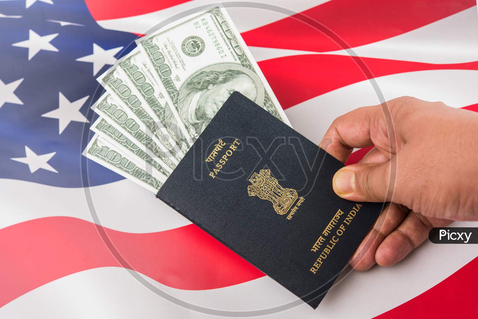 Indian passport with US Dollars with american flag in the background, Concept showing applying for tourist or H-1B visa