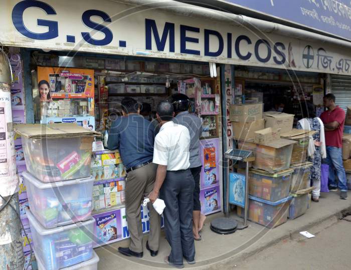 People buy medicines in a chemist shop