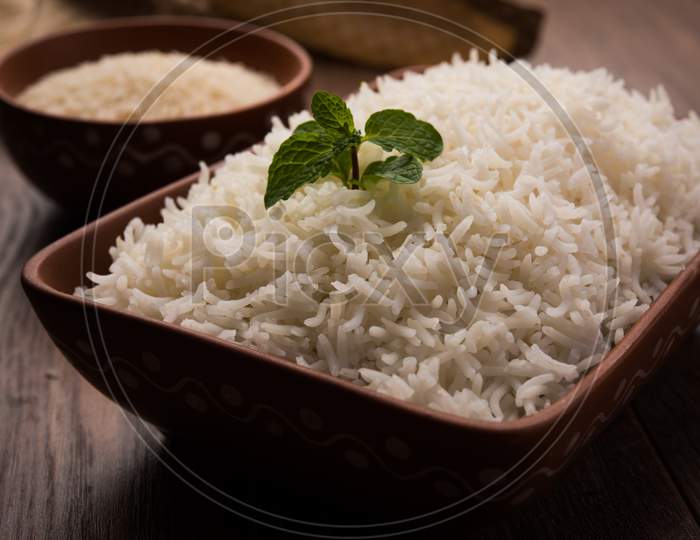 Cooked plain white basmati rice in terracotta bowl