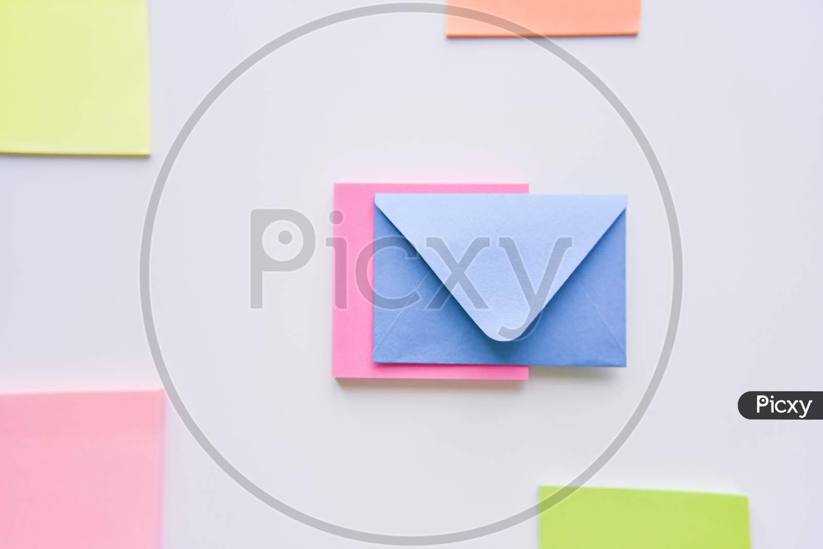 Selective Focus, Blue Envelope In The Center With Colored Rectangles On Sides