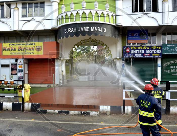 Assam State Fire and Emergency Service worker spray disinfectants at Burha Jame Masjid