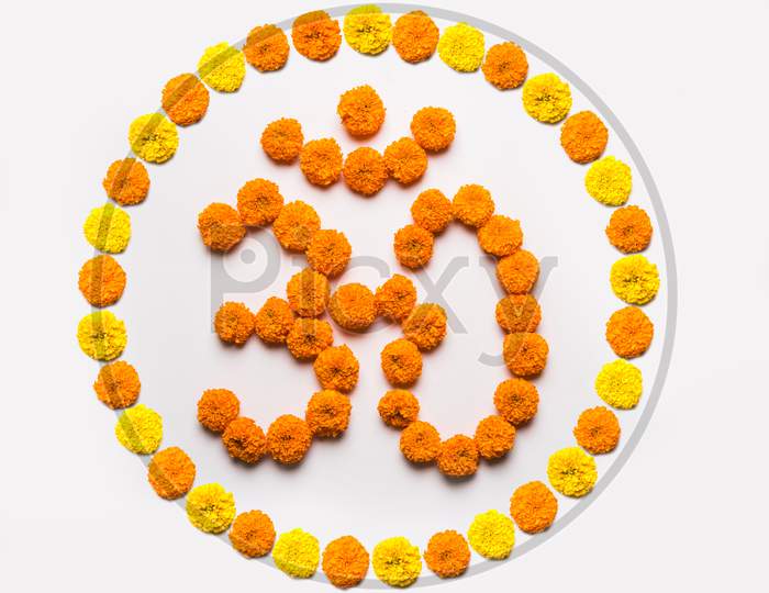 Stock photo of word Aum or om made using marigold flower arrangement