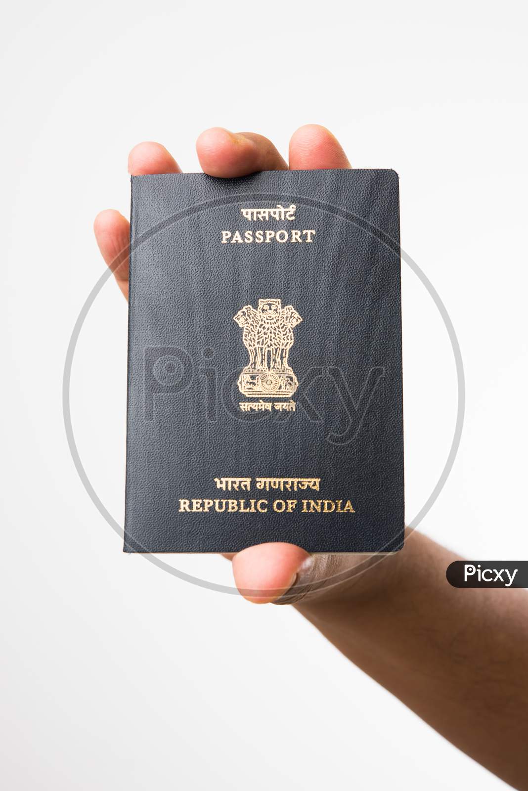 Hand holding Indian Passport