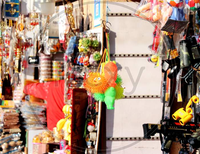 Amritsar, Punjab, India - December 03 2019: Toys And Accessories Hang In The Market Of Amritsar Golden Temple