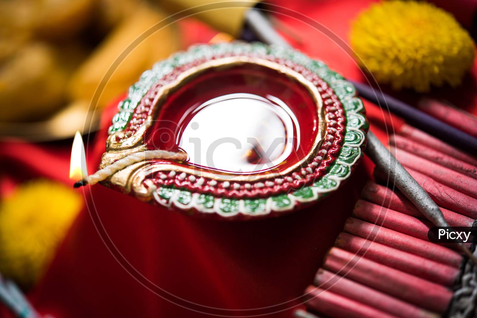 Diwali Diya, Sweets OR Mithai, Gift boxes and Crackers arranged over moody background